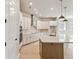 Modern kitchen with stainless steel appliances, white cabinets, and a center island with pendant lights at 6221 Trailblaze Bnd, St Cloud, FL 34771