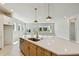 Open concept kitchen with a large island, stainless steel appliances, and view into the living area at 6221 Trailblaze Bnd, St Cloud, FL 34771