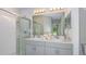 Bathroom featuring dual sinks, vanity and a walk-in shower at 7347 Capstone Dr, Groveland, FL 34736
