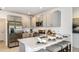 Modern kitchen featuring stainless steel appliances, light gray cabinets, and a breakfast bar at 7347 Capstone Dr, Groveland, FL 34736