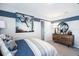 Stylized bedroom features cool color accents, wardrobe, and ample natural light at 7396 Capstone Dr, Groveland, FL 34736