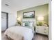 Calm bedroom featuring soft lighting and a comfortable bed with decorative pillows at 7396 Capstone Dr, Groveland, FL 34736