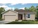 Charming single-story home with a two-car garage and well-maintained landscaping at 7396 Capstone Dr, Groveland, FL 34736