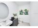 Well-lit powder room with elegant fixtures, vanity, and modern decor at 7396 Capstone Dr, Groveland, FL 34736