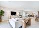 Open-concept living room with contemporary furnishings, neutral tones, and seamless flow to dining area at 7396 Capstone Dr, Groveland, FL 34736