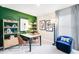 Stylish home office with shelving, modern artwork, and a comfortable workspace at 7396 Capstone Dr, Groveland, FL 34736