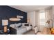 Cozy bedroom with a themed accent wall, comfortable bed, and well-lit study area for a  at 7605 Waterscape Dr, Groveland, FL 34736