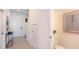 Hallway featuring stylish decor, including a modern table, mirror, and partial view of a powder room at 7605 Waterscape Dr, Groveland, FL 34736