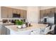 Modern kitchen featuring an island with white countertops, stainless steel appliances, and stylish gray cabinets at 7605 Waterscape Dr, Groveland, FL 34736