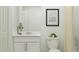 Clean bathroom features a white vanity, modern fixtures, and a shower with curtain at 958 Hour Glass Rd, Lakeland, FL 33801