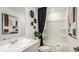 Bright bathroom with a tub, vanity and modern fixtures and decor at 2569 Penguin Blvd, Davenport, FL 33837