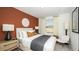 Stylish bedroom with a decorative headboard, modern lamps, and a cozy accent chair at 2569 Penguin Blvd, Davenport, FL 33837