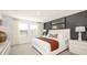 This well-lit primary bedroom is styled with neutral colors and modern decor at 2569 Penguin Blvd, Davenport, FL 33837