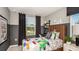 Bright bedroom with a colorful patchwork quilt, decorative pillows, and a modern desk area at 2569 Penguin Blvd, Davenport, FL 33837
