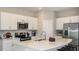 Bright kitchen with a large island, stainless appliances, and white cabinets at 2569 Penguin Blvd, Davenport, FL 33837