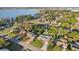An aerial view displays a well-maintained home with lush greenery and a nearby lake at 1841 5Th Se St, Winter Haven, FL 33880