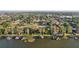 An aerial view shows a waterfront community with private docks and lush landscaping at 1841 5Th Se St, Winter Haven, FL 33880