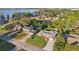 An aerial view showcases the cozy neighborhood near a tranquil lake at 1841 5Th Se St, Winter Haven, FL 33880