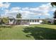 Beautiful backyard with a spacious lawn and partial view of the home's screened in patio, perfect for relaxation at 1841 5Th Se St, Winter Haven, FL 33880