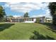 Expansive backyard with green lawn and exterior view of the house at 1841 5Th Se St, Winter Haven, FL 33880