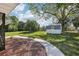 Well-maintained backyard with lush green lawn, shed, and concrete walkway at 1841 5Th Se St, Winter Haven, FL 33880