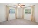 Bedroom featuring carpet, two windows with curtains and ceiling fan at 1841 5Th Se St, Winter Haven, FL 33880