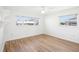 Bright bedroom featuring wood-look floors, and two windows at 1841 5Th Se St, Winter Haven, FL 33880