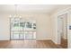 Bright dining room featuring wood floors, chandelier, and sliding glass doors to sunroom at 1841 5Th Se St, Winter Haven, FL 33880