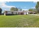 Well-maintained brick home with a green lawn, established landscaping, and a driveway, offering a welcoming facade at 1841 5Th Se St, Winter Haven, FL 33880
