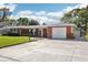 Charming brick home with a well-manicured front yard, a driveway, and an attached garage, showcasing curb appeal at 1841 5Th Se St, Winter Haven, FL 33880