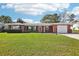 Charming single story home featuring a brick facade, attached garage, and a spacious green lawn at 1841 5Th Se St, Winter Haven, FL 33880