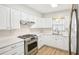 Bright kitchen with modern stainless steel appliances and white cabinets at 1841 5Th Se St, Winter Haven, FL 33880
