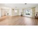 Open living room showcasing wood floors, neutral paint, and ample natural light from a large window at 1841 5Th Se St, Winter Haven, FL 33880