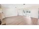 Spacious living room with hardwood floors and sliding glass doors to a sunroom at 1841 5Th Se St, Winter Haven, FL 33880