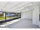 Spacious screened-in patio with white walls and ceiling, and view to backyard at 1841 5Th Se St, Winter Haven, FL 33880