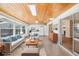 Inviting sun room featuring wood ceiling, white sofas, and backyard view at 1841 5Th Se St, Winter Haven, FL 33880