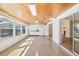 Bright sun room with wood ceiling, white appliances, and sliding door to other room at 1841 5Th Se St, Winter Haven, FL 33880