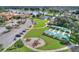 Aerial view featuring the community pool, tennis courts, and playground at 474 Del Sol Ave, Davenport, FL 33837