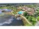 Aerial view showcasing the community pool, lake, and clubhouse at 474 Del Sol Ave, Davenport, FL 33837