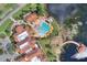 Aerial view of a community pool, clubhouse, and surrounding landscaping at 474 Del Sol Ave, Davenport, FL 33837