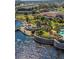 An aerial view showcases the pool and clubhouse along a lake with a walking path at 474 Del Sol Ave, Davenport, FL 33837
