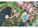 Aerial view of a community pool, clubhouse, dock, and surrounding landscaping at 474 Del Sol Ave, Davenport, FL 33837