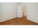 Bedroom with hardwood floors, natural light, and an open doorway leading to bathroom at 474 Del Sol Ave, Davenport, FL 33837
