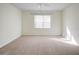 Bright, carpeted bedroom with ceiling fan and natural light from window at 474 Del Sol Ave, Davenport, FL 33837