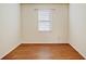 Empty room with wood-look floors and a single window, ready to customize at 474 Del Sol Ave, Davenport, FL 33837