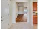 Bright foyer featuring tile flooring, white walls, and a view into the living area with wood floors at 474 Del Sol Ave, Davenport, FL 33837