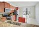 Well-equipped kitchen featuring granite countertops, stainless steel appliances, and a center island at 474 Del Sol Ave, Davenport, FL 33837