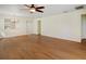 Large living room with hardwood floors, ceiling fan, and open access to the rest of the home at 474 Del Sol Ave, Davenport, FL 33837