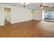 Open living room with wood floors, ceiling fan, and sliding doors to an outdoor space at 474 Del Sol Ave, Davenport, FL 33837