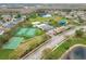 Community aerial view showcasing tennis courts, basketball court, playground, pool, and lush landscaping at 14110 Sapphire Bay Cir, Orlando, FL 32828